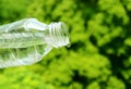 Drinking water drop out from plastic bottle Royalty Free Stock Photo