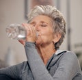 Drinking water, fitness and retirement with a senior woman in her home for wellness or hydration. Exercise, drink or