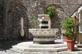 Drinking water fountain from marble with lion heads on a square in the old town of porto venere, liguria, italy Royalty Free Stock Photo