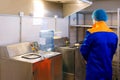 Drinking water treatment plant, factory worker inspect a plastic bottle, monitor cleanliness Royalty Free Stock Photo