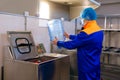 Drinking water treatment plant, factory worker inspect a plastic bottle, monitor cleanliness Royalty Free Stock Photo