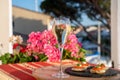 Drinking of white cold champagne, bliny with red caviar and view on Port Grimaud near Saint-Tropez in summer