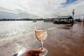 Drinking white wine on Venice embankment during the flood. Bar visitor walking past water canals of famous italian city Royalty Free Stock Photo