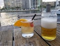 drinks alongside a waterfront view of a boat canal.