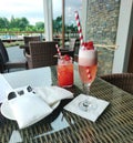 Drinks, glass with prosecco-based cocktail, lemonade, beautiful garnish, fresh strawberries, straws, cutlery, restaurant
