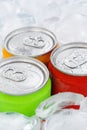 Drinks lemonade cola drink softdrinks in cans with ice cubes portrait format Royalty Free Stock Photo