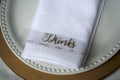 Drinks menu over white plate and napkin