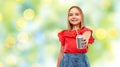 Smiling preteen girl drinking soda from can