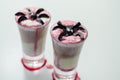 Drinks shots prepared by the bartender at the Halloween party decorated with black olives in the shape of spiders