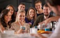 Drinks and a show. Shot of a happy group of friends having drinks at a bar together. Royalty Free Stock Photo