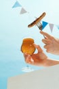 Drinks and snacks. Male hand with glass, mug of cold light beer over light blue sky background. Oktoberfest, vacation Royalty Free Stock Photo