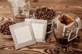 Drip bag of fresh drink in a glass with coffee beans on background. Royalty Free Stock Photo