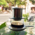 Drip Black Coffee in Vietnamese style with condensed milk on a glass table. Royalty Free Stock Photo