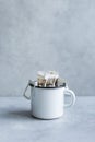 Drip or brewed coffee on gray background, paper dripping bag on a white cup. Specealty coffee at home Royalty Free Stock Photo