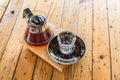 Drip coffee cup and coffee pot on wood table. Royalty Free Stock Photo