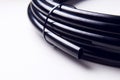Drip irrigation system close-up. Fragment of a drip irrigation hose in a roll. Tied roll of irrigation hose. Royalty Free Stock Photo