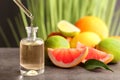 Dripping citrus essential oil into bottle on table