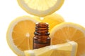 Dripping citrus essential oil into bottle on white background