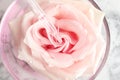 Dripping essential oil onto fresh rose in glass bowl Royalty Free Stock Photo