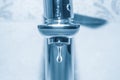 Dripping faucet on blue background Royalty Free Stock Photo