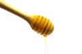 Dripping honey on wooden dipper or wooden spoon isolated on whit Royalty Free Stock Photo