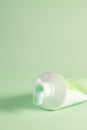 Dripping mint toothpaste tube isolated on green background - the concept of oral health Royalty Free Stock Photo