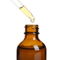 Dripping natural tea tree essential oil into bottle Royalty Free Stock Photo