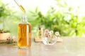 Dripping natural tea tree essential oil into bottle on table Royalty Free Stock Photo