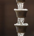 Frozen Downspout on Brown Background