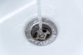 Dripping water from the single handle mixer tap mounted on a wash basin Royalty Free Stock Photo