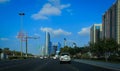 Drive in Abu Dhabi city corniche road with view of famous towers against blue sky and clouds