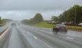 Drive car in rain on asphalt wet road. Cars the traffic light