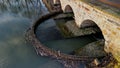 drive of the mill under bridge. water is filtered through sieve grid so that Royalty Free Stock Photo