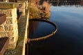 Drive of the mill under the bridge. the water is filtered through a sieve grid so that farmed fish do not swim away. water purific Royalty Free Stock Photo