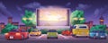 Drive-in movie theater with cars and glowing big screen