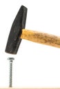 Drive screw in with a hammer - the wrong tool Royalty Free Stock Photo