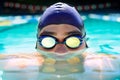 Driven to improve his lap time. Cropped view of a determined male swimmer swimming laps.