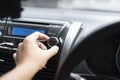 Driver is adjusting radio volume in the car during traffic Royalty Free Stock Photo