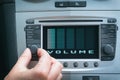 Driver adjusting volume in the car audio system Royalty Free Stock Photo