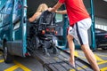 Disabled person on wheelchair using van ramp Royalty Free Stock Photo