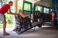 Disabled person on wheelchair using van ramp