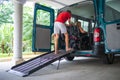 Disabled person on wheelchair using van ramp Royalty Free Stock Photo