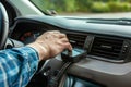 driver attaching a handsfree device to the dashboard
