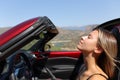 Driver breathing fresh air in a convertible car Royalty Free Stock Photo