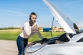 Driver with broken car making phone call Royalty Free Stock Photo