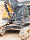 Driver cabin and continuous tracks on a heavy excavator digger machine