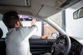 Driver in car paying toll booth bill payment of expressway tex at the highway road, man getting a ticket, shot from inside of the Royalty Free Stock Photo