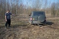 Driver of the car UAZ-Patriot pulls out dirt jammed machine