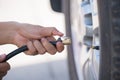 Driver checking air pressure and filling air in the tires Royalty Free Stock Photo