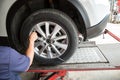 driver checking air pressure and filling air in the tires close up. Royalty Free Stock Photo